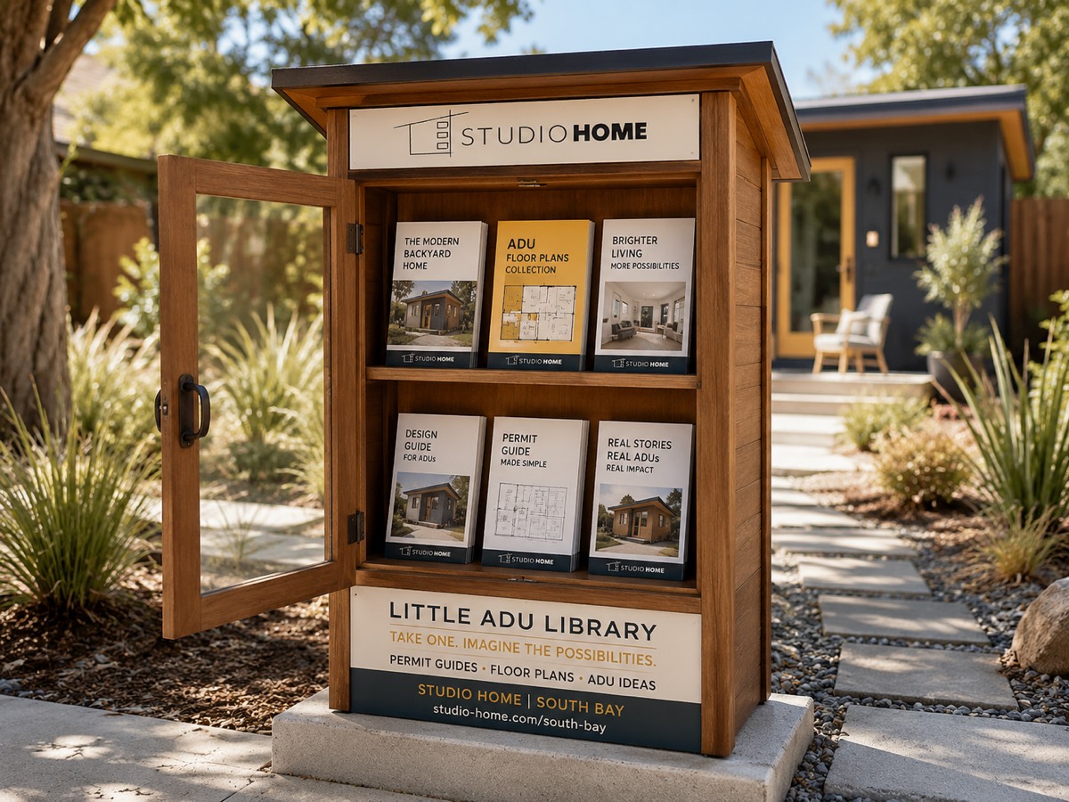 The Little ADU Library open, showing six booklet covers across two shelves, with a completed backyard studio behind it.