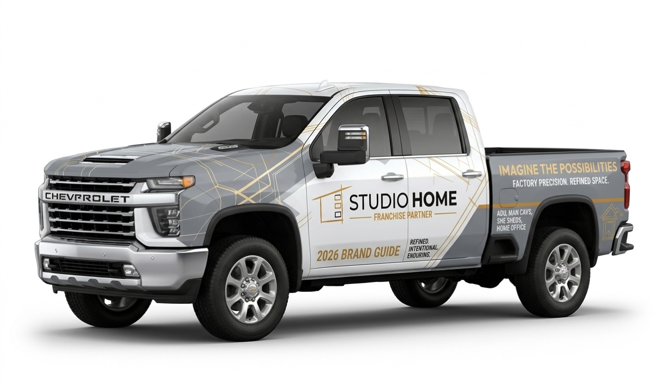 Studio Home franchise partner wrap on a Chevrolet Silverado HD in white and stone grey with topaz linework.